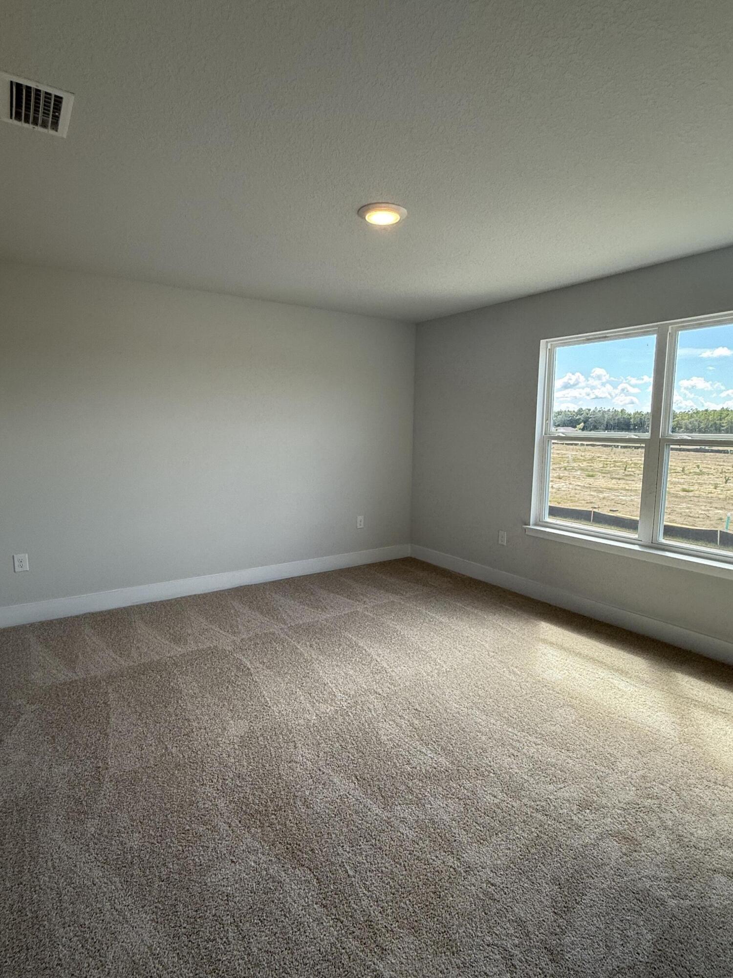 2410 Aleia Lane Crestview, FL 32536 - Photo 13 of 37 an empty room with windows