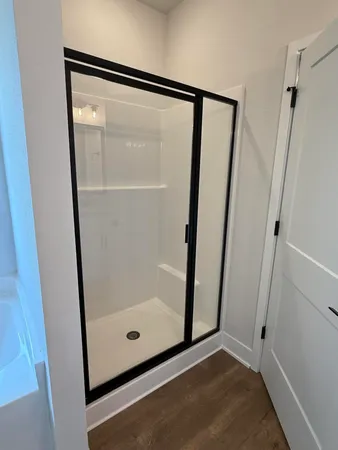 a bathroom with a glass shower door