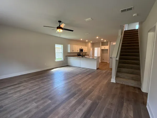 a view of a kitchen with wooden floors and a fireplace