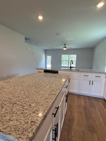 a kitchen with granite countertop a sink and a stove
