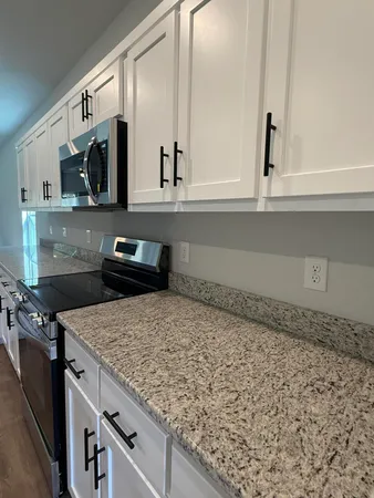 a kitchen with a stove and a microwave