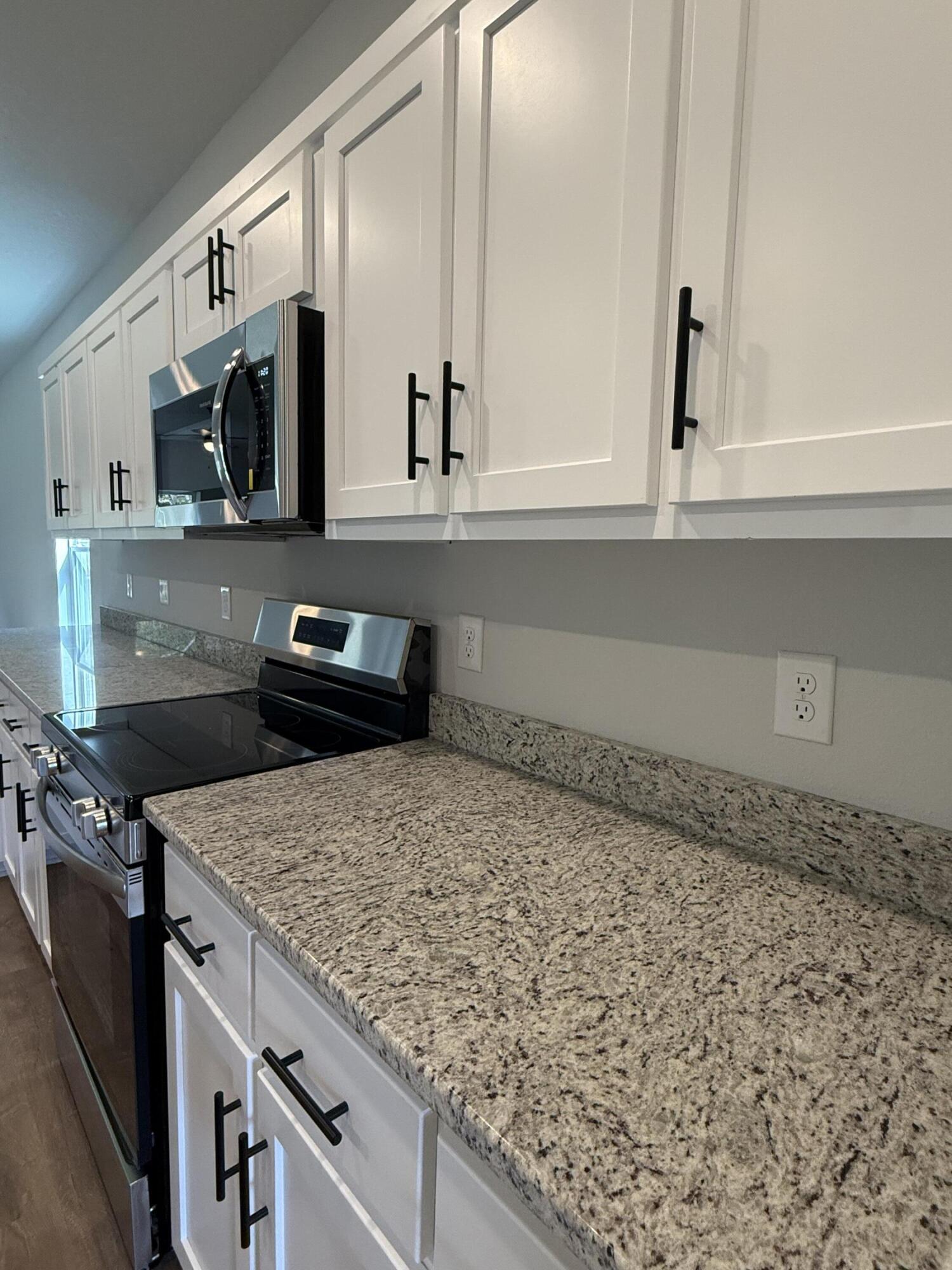 2410 Aleia Lane Crestview, FL 32536 - Photo 31 of 37 a kitchen with a stove and a microwave