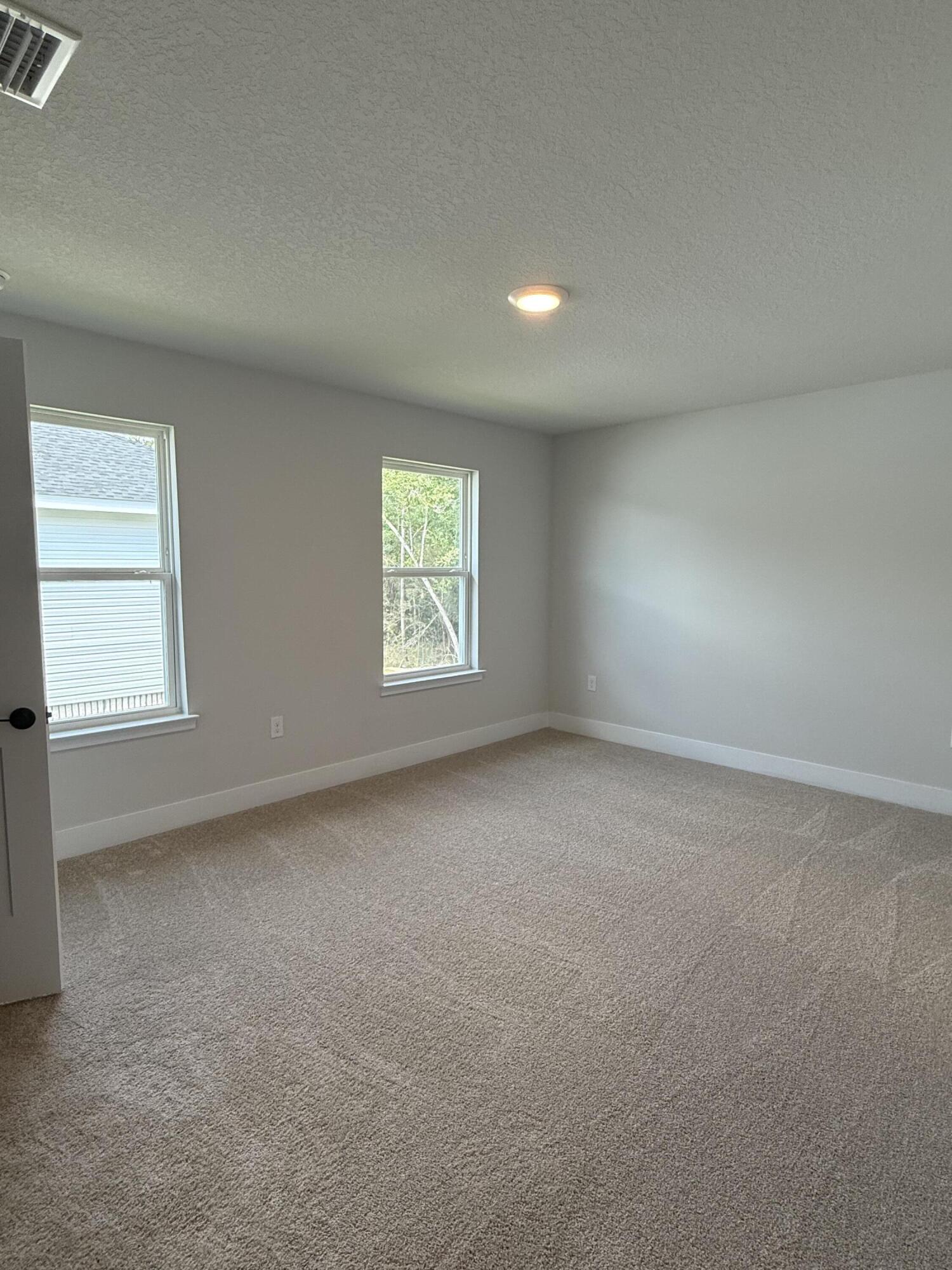 2410 Aleia Lane Crestview, FL 32536 - Photo 9 of 37 an empty room with a window
