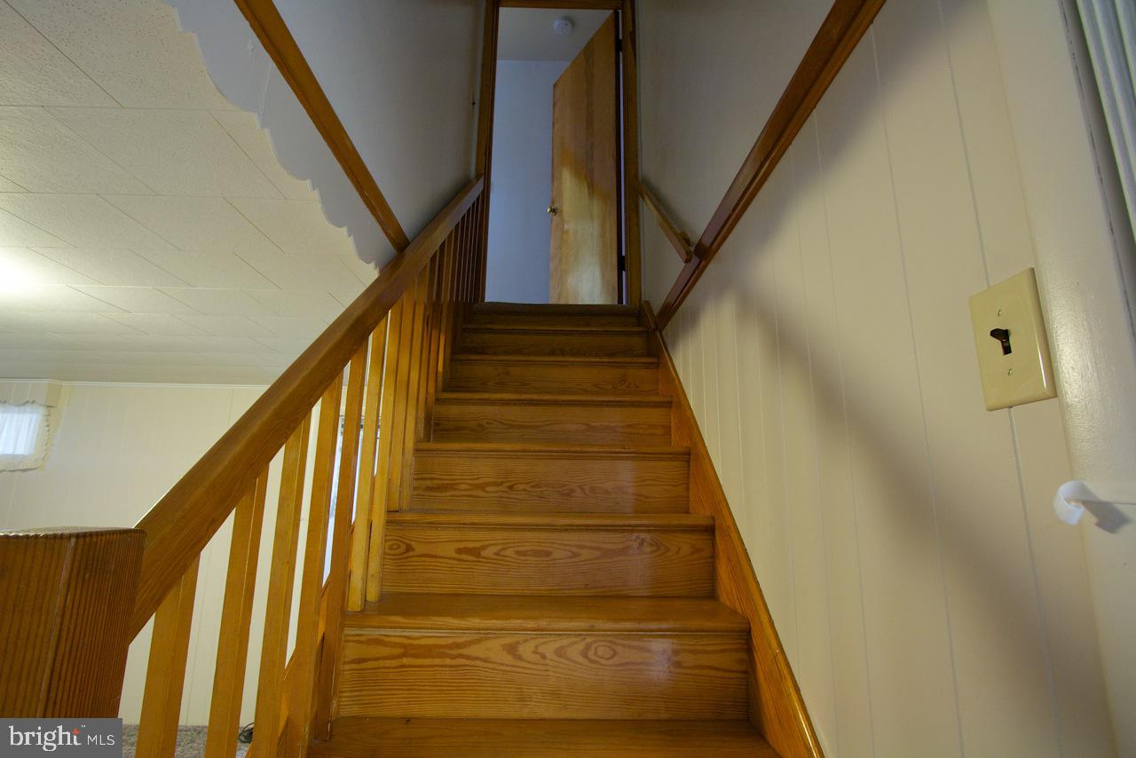 8110 Woodhaven Road Baltimore, MD 21237 - Photo 7 of 25 Hardwood stairs leading to upper level