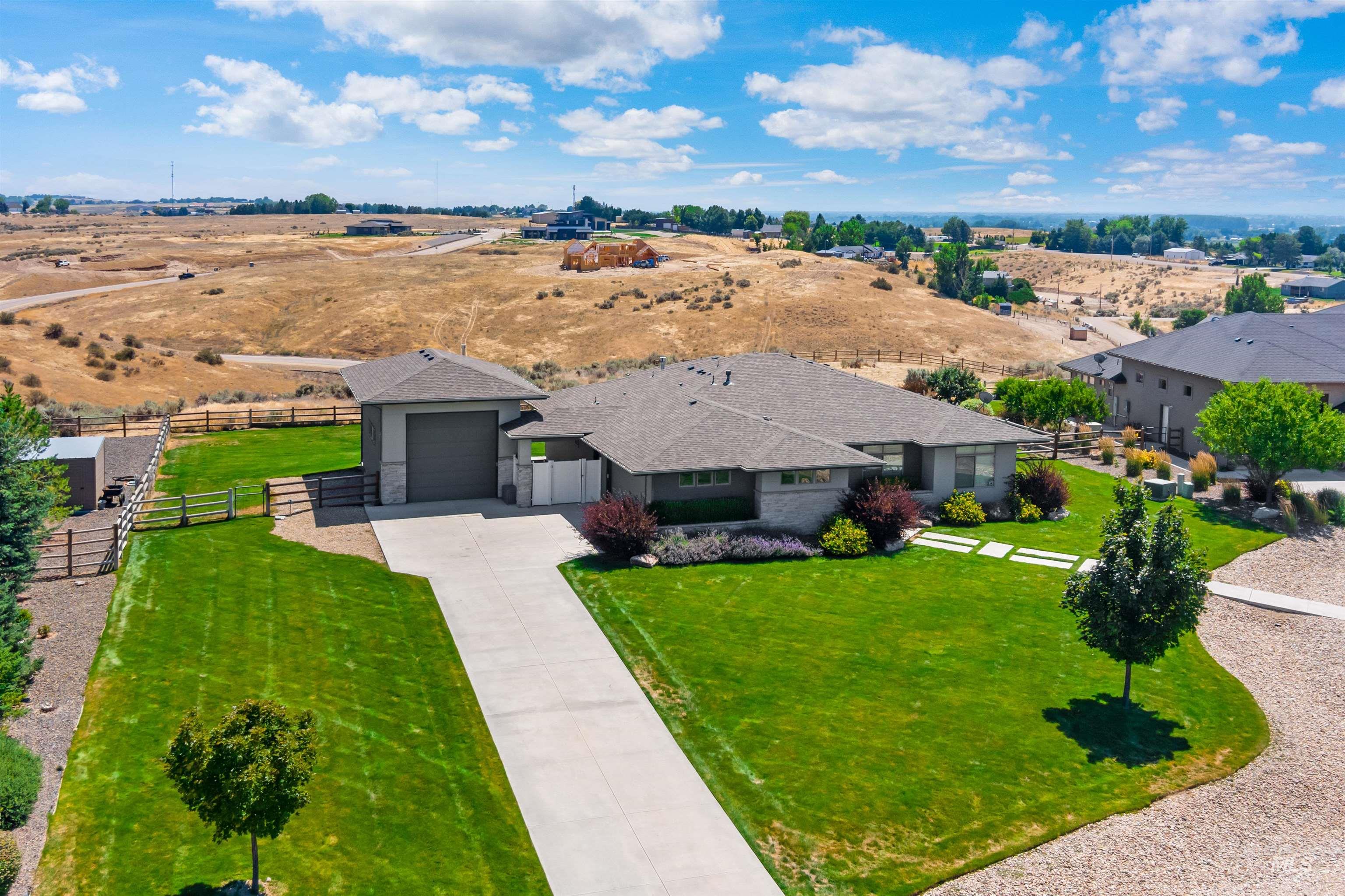 24398 Tombstone Ridge Court Middleton, ID 83644 - Photo 34 of 47 Ranch-style residence featuring a detached garage, expansive concrete driveway, and a verdant front lawn