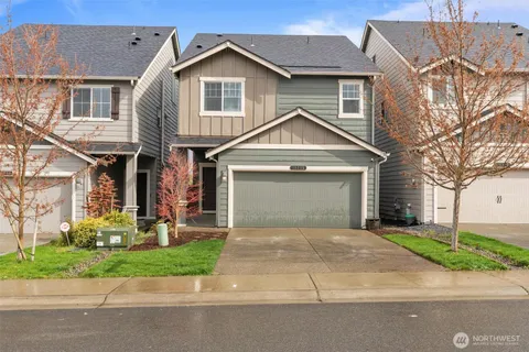 a front view of a house with a yard and garage