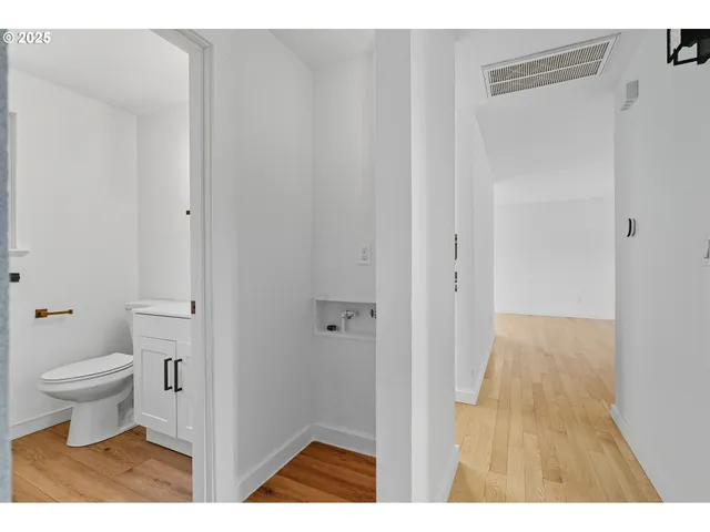 a bathroom with a sink a toilet and mirror