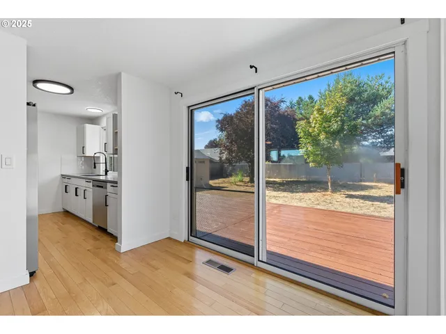 a view of open kitchen with wooden floor and a kitchen