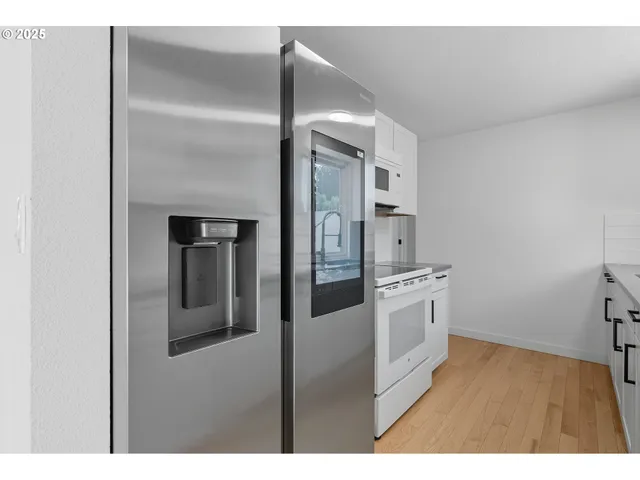 a kitchen with a refrigerator and a sink