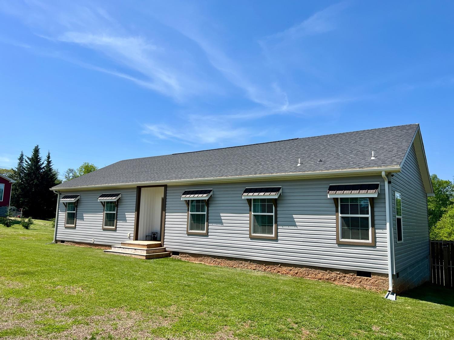a front view of house with yard and outdoor seating