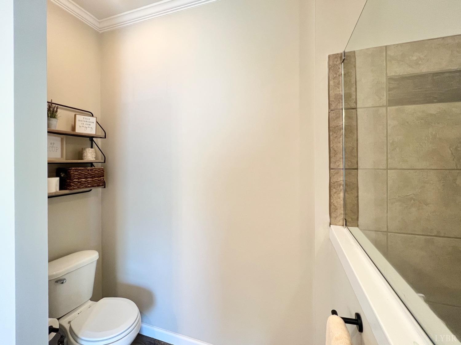 2747 Five Forks Road Bedford, VA 24523 - Photo 26 of 40 a white toilet sitting next to a white sink and vanity
