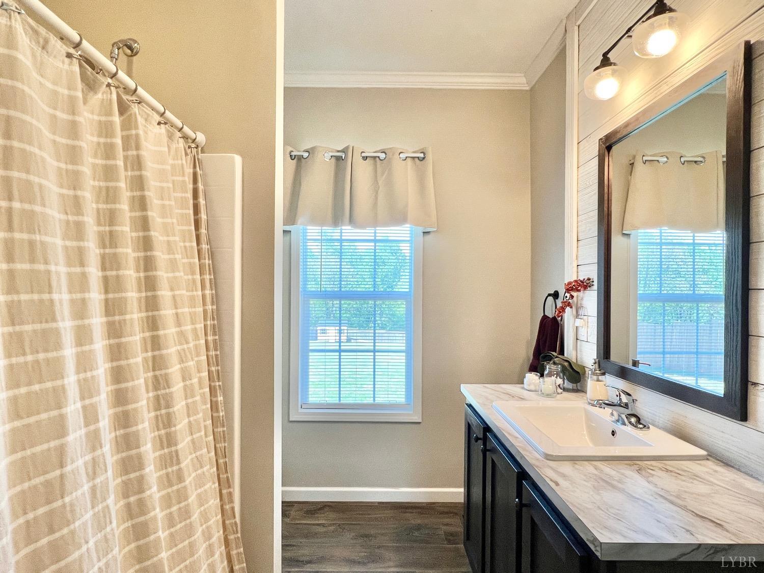 2747 Five Forks Road Bedford, VA 24523 - Photo 30 of 40 a bathroom with a granite countertop sink a mirror and a shower