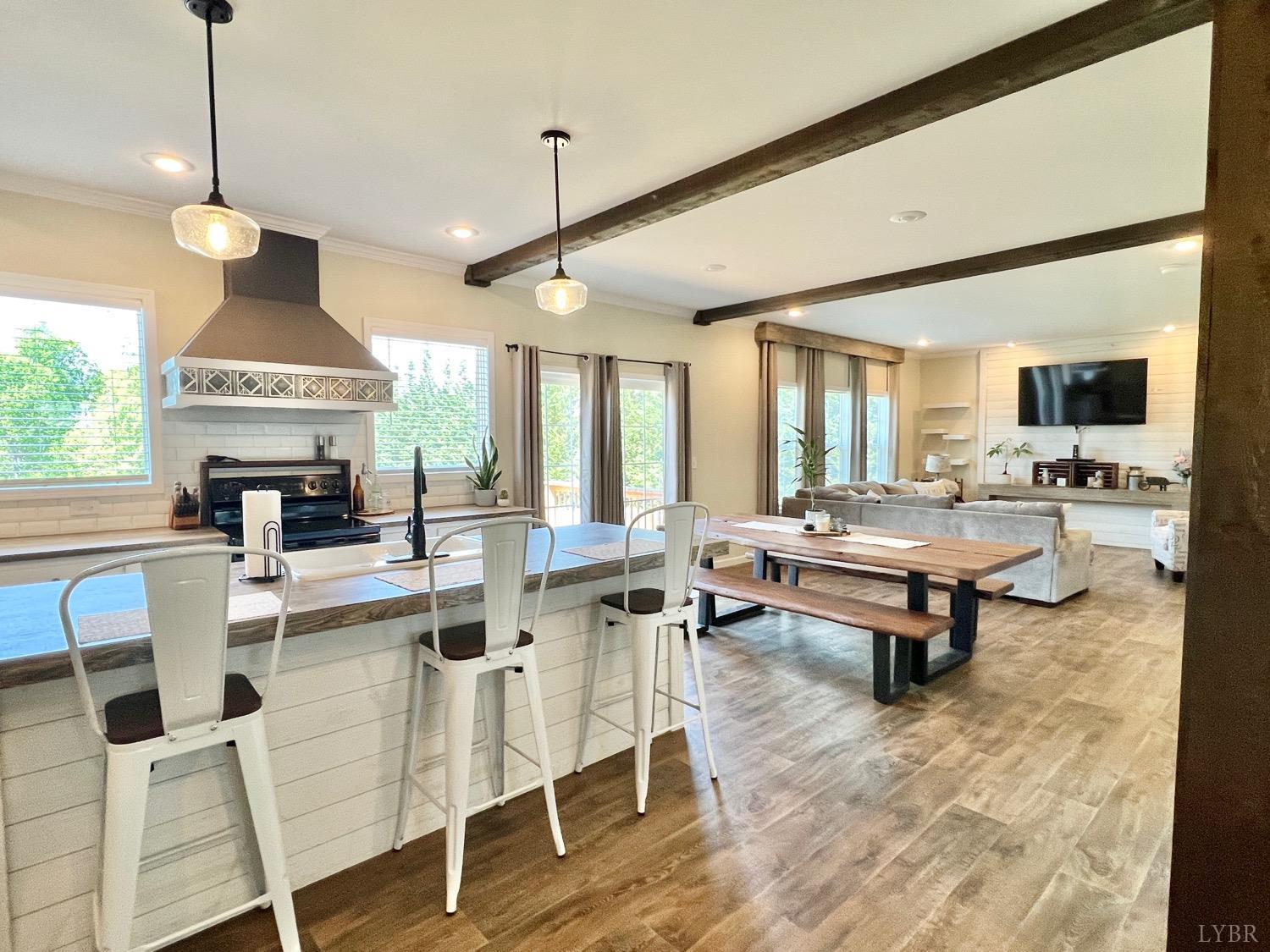 2747 Five Forks Road Bedford, VA 24523 - Photo 10 of 40 a living room with furniture a rug and a chandelier