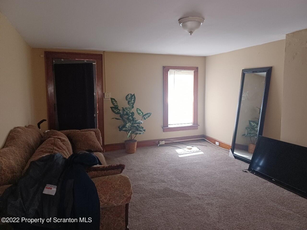415 Maple Street Scranton, PA 18505 - Photo 12 of 22 a living room with furniture and a window