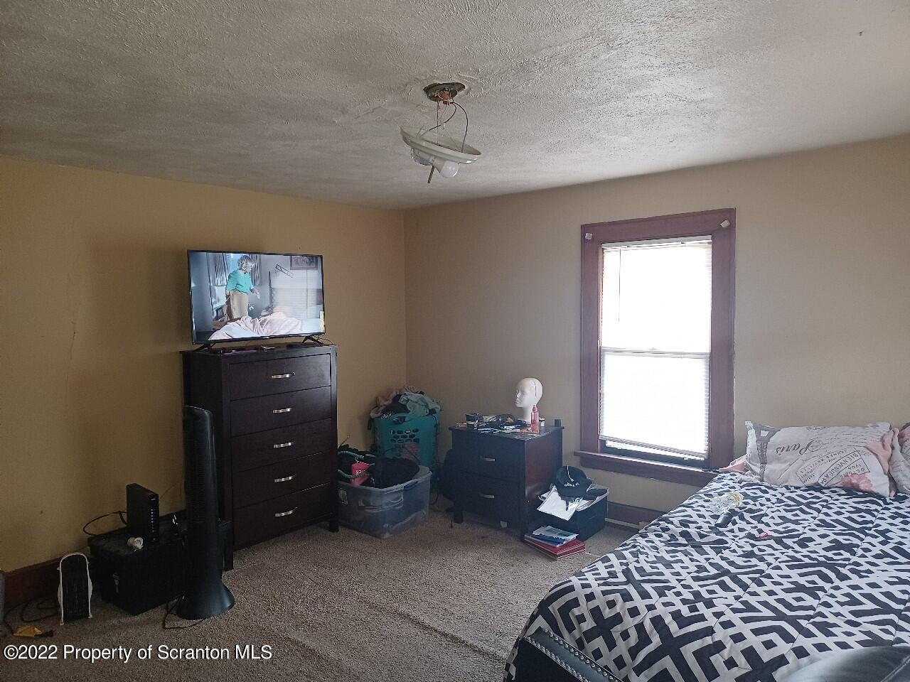 415 Maple Street Scranton, PA 18505 - Photo 14 of 22 a bedroom with a bed and a window