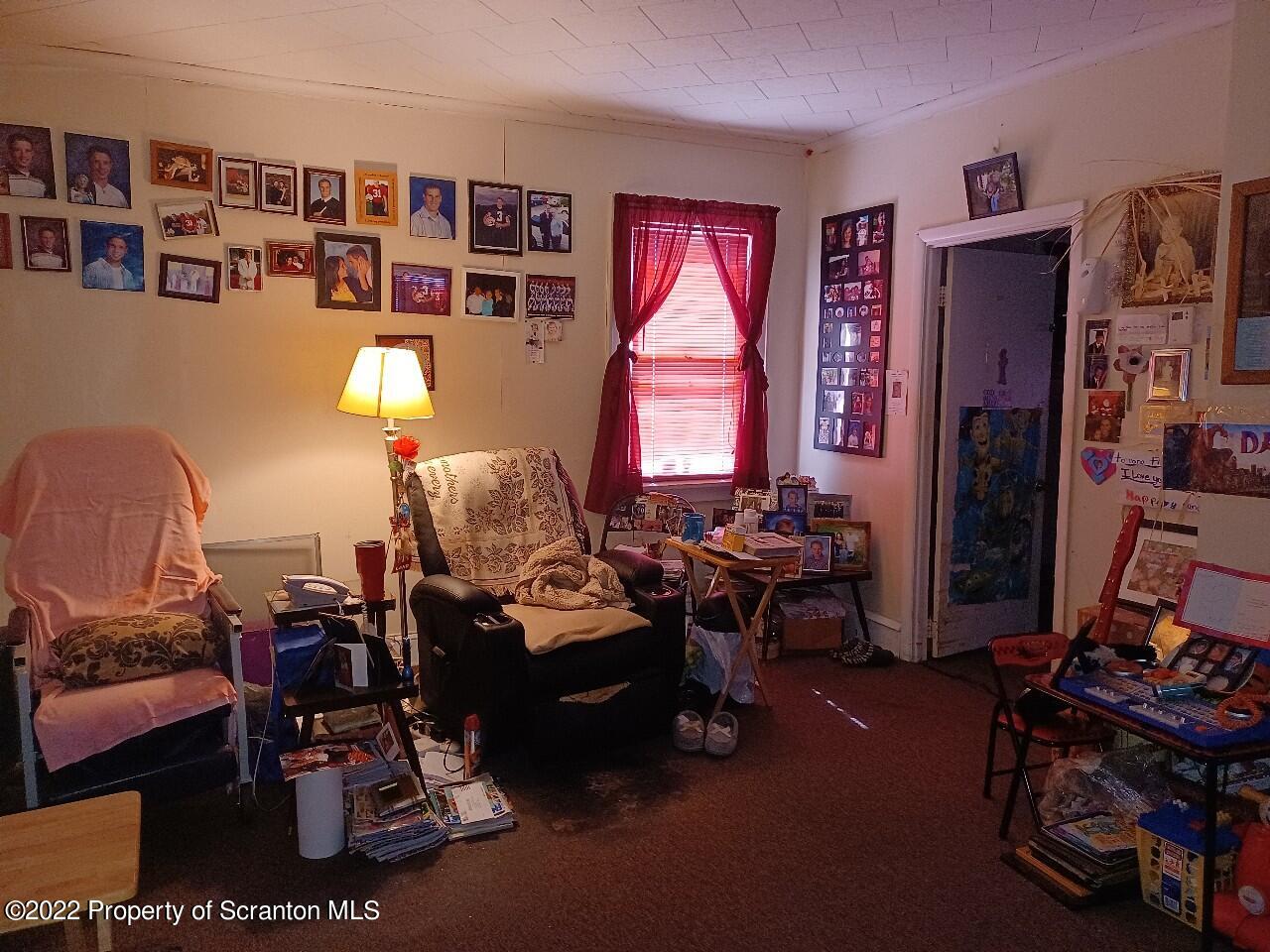 415 Maple Street Scranton, PA 18505 - Photo 7 of 22 a living room with furniture a rug and a large window
