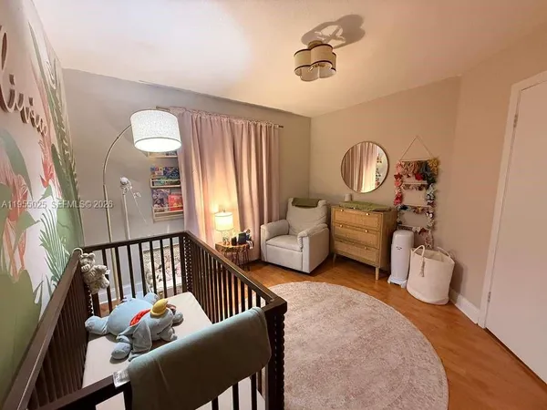 a living room with furniture stairs and a window