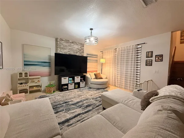 a living room with furniture and a flat screen tv