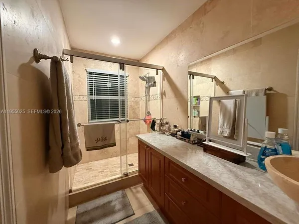 a bathroom with double vanity and a bathtub