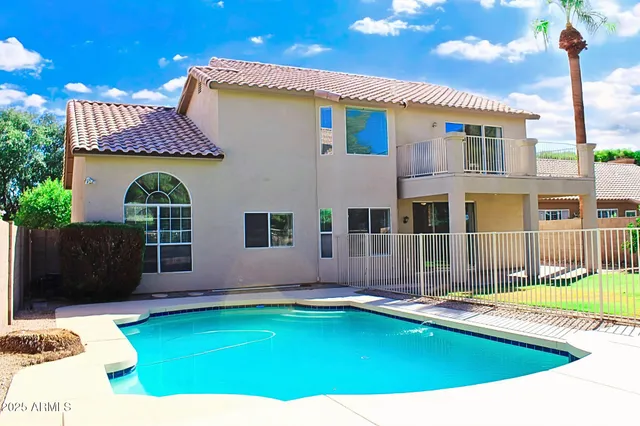 a swimming pool with outdoor seating and yard