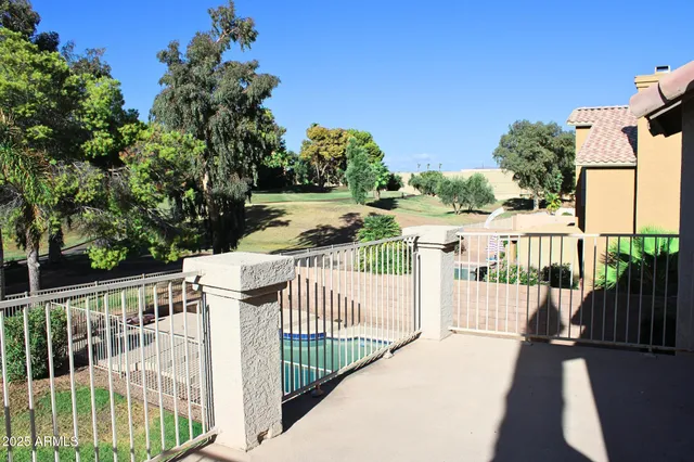 a view of a balcony with wooden fence