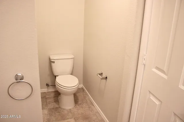 a white toilet sitting next to a bathroom sink