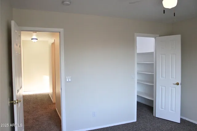 a view of an empty room and a bathroom
