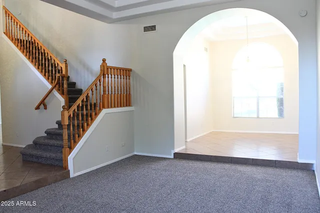 an entryway with wooden floor and windows