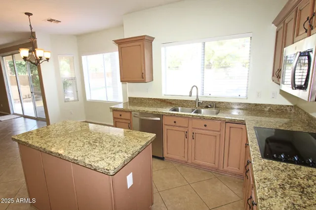 a kitchen with granite countertop sink stove and granite counter tops