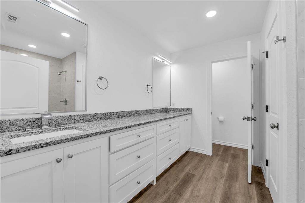 204 North Wiebusch Street Riesel, TX 76682 - Photo 16 of 33 a bathroom with a granite countertop double vanity sink and mirror