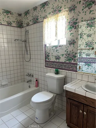 a bathroom with a sink a toilet and bathtub