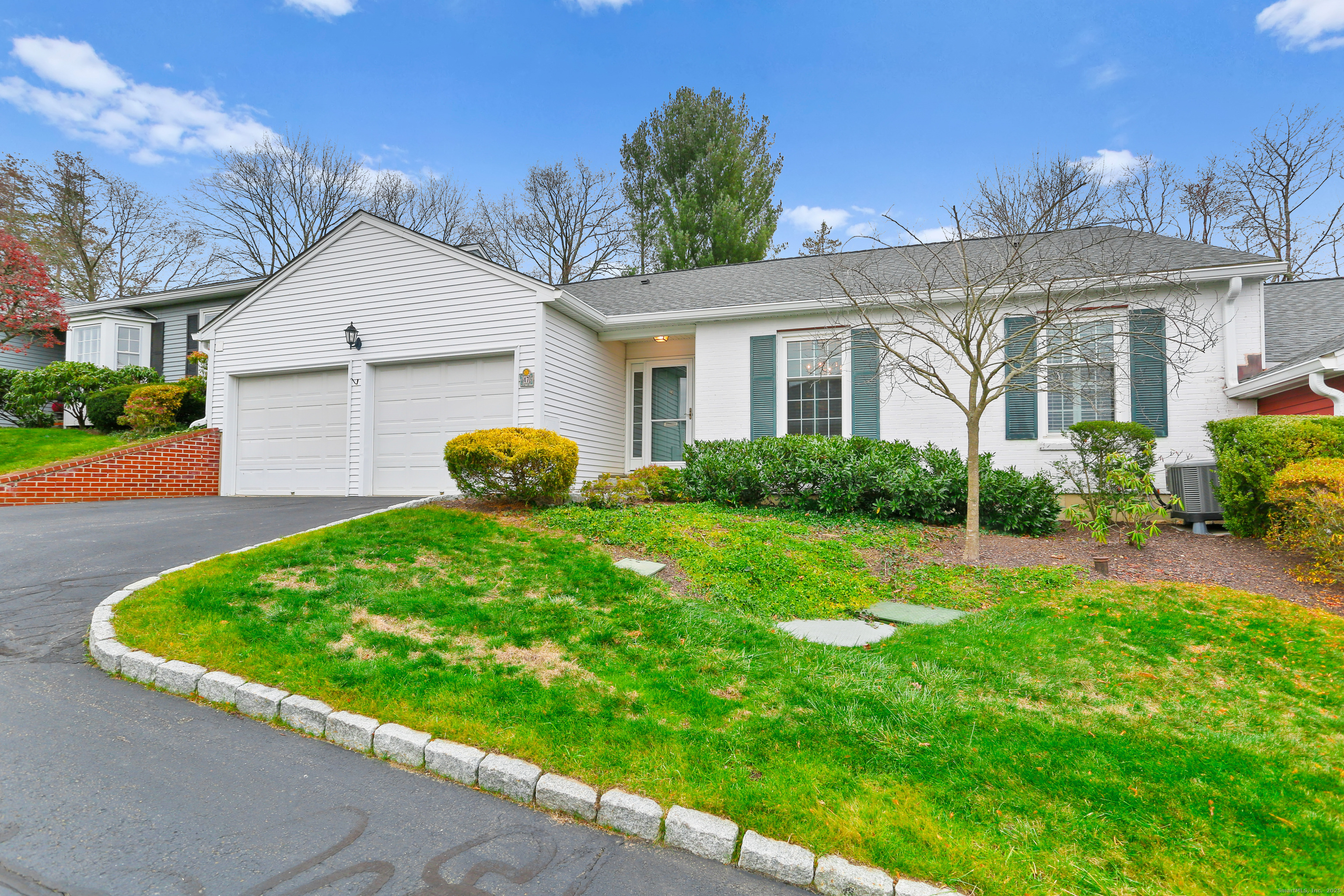 a front view of house with yard and green space