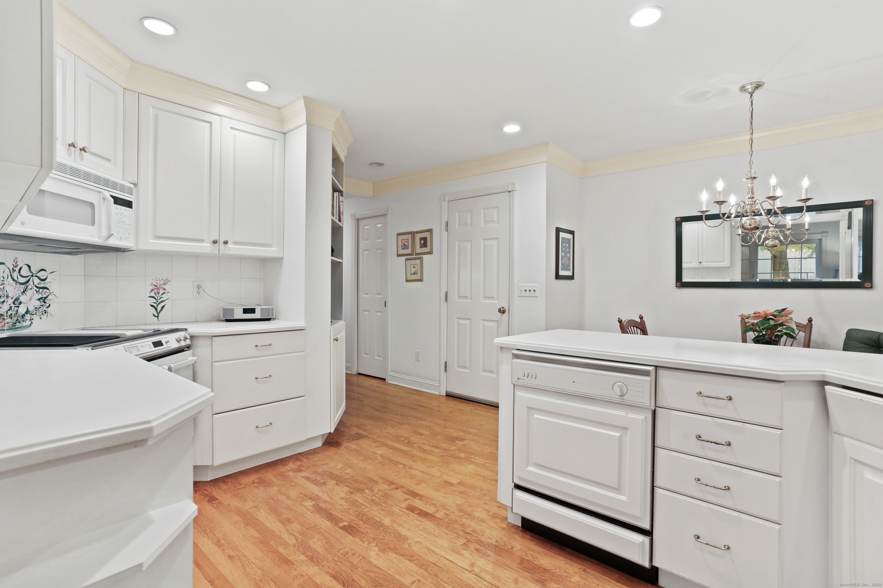 47 Bank Street, Unit 47 New Canaan, CT 06840 - Photo 19 of 40 a kitchen with white cabinets and sink