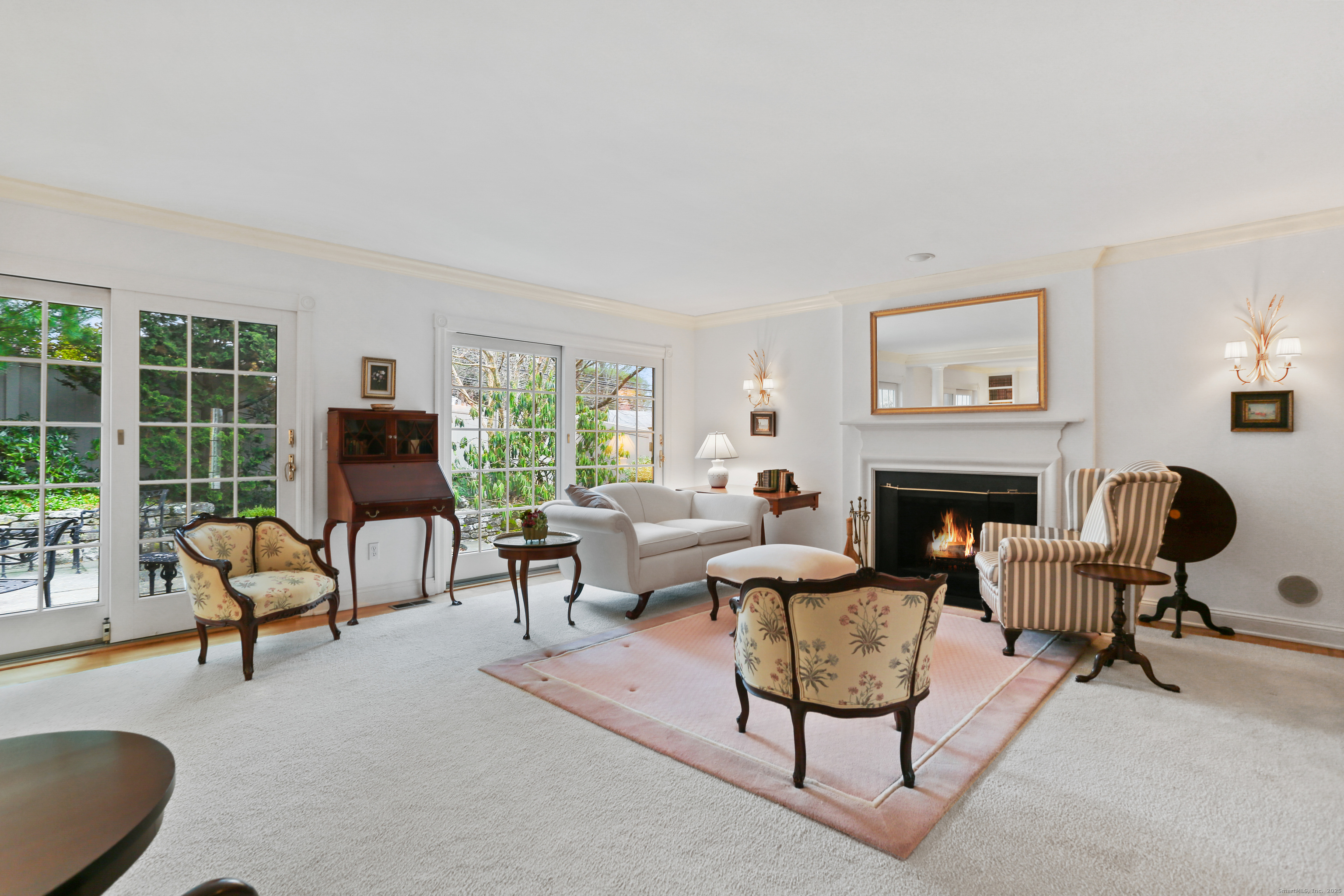 47 Bank Street, Unit 47 New Canaan, CT 06840 - Photo 22 of 40 a living room with furniture fireplace and a large window