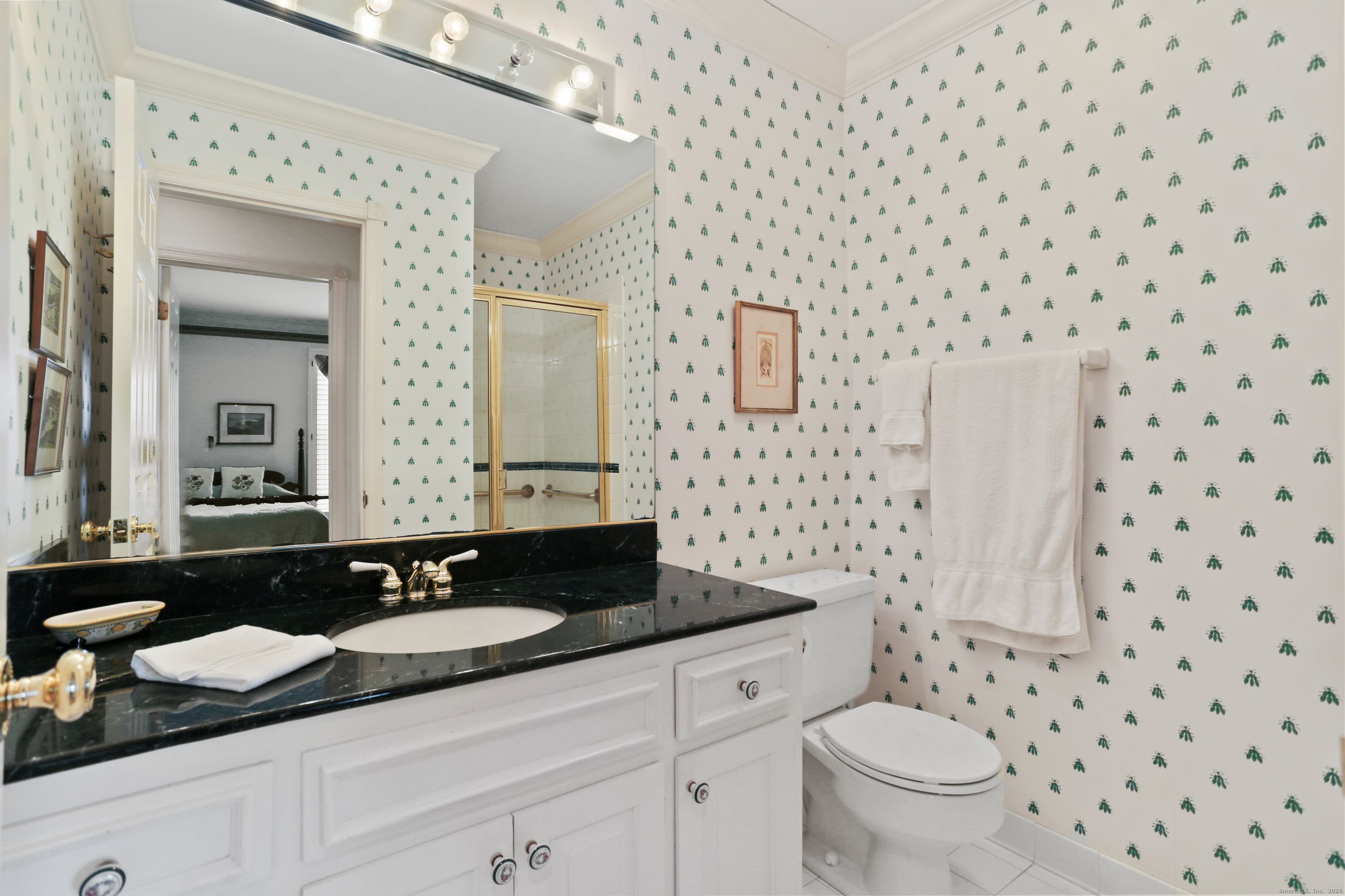 47 Bank Street, Unit 47 New Canaan, CT 06840 - Photo 32 of 40 a bathroom with a granite countertop sink and a mirror