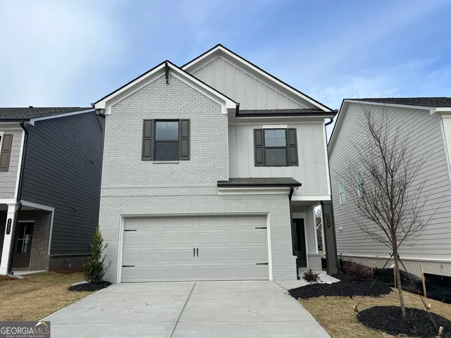 a front view of a house with garage