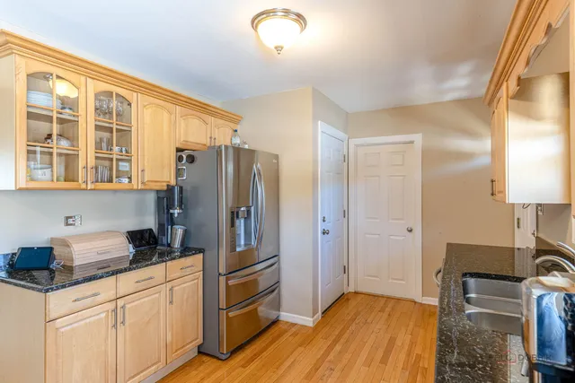a kitchen with a refrigerator and a sink