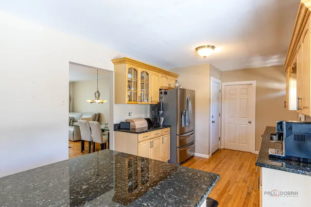 a bedroom with a bed and a view of living room