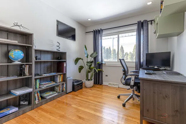 a view of a workspace with furniture and a window