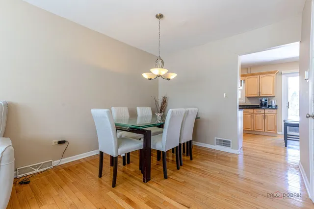 a dining room with furniture and wooden floor