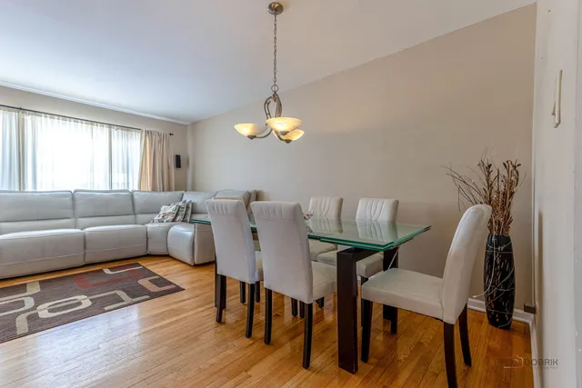 a living room with furniture a dining table and a window