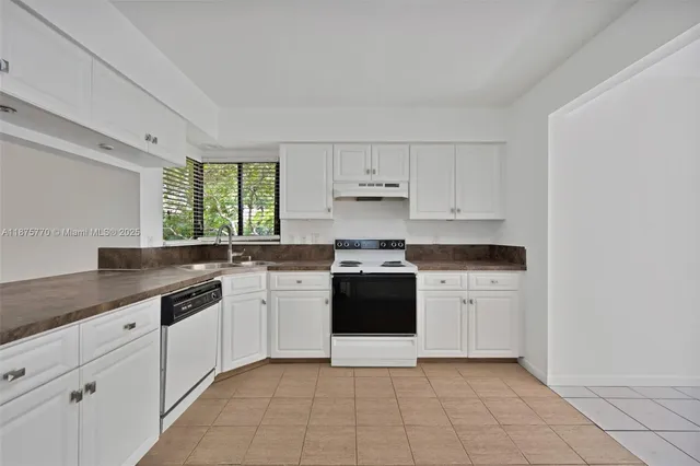 a kitchen with a sink stove and cabinets