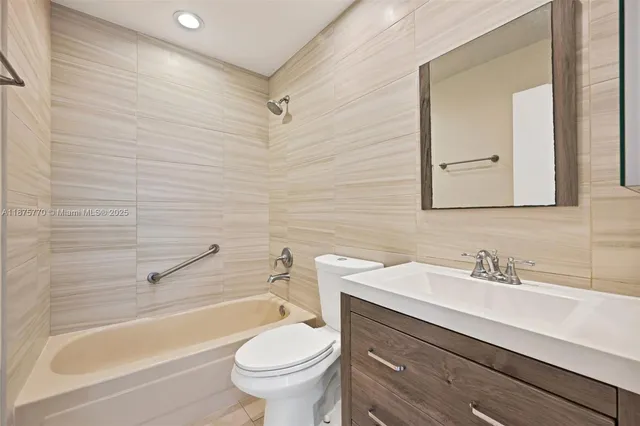 a bathroom with a sink a toilet and a bathtub