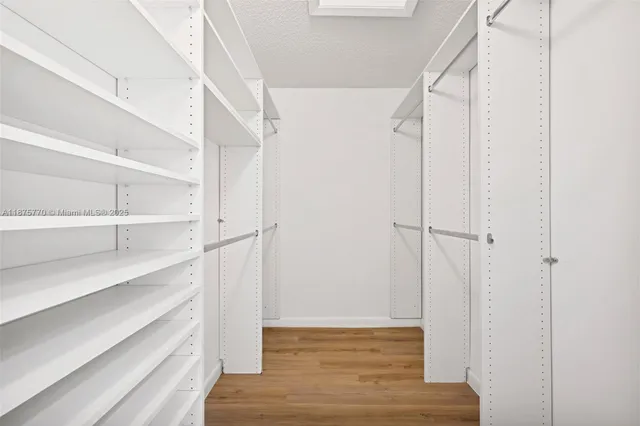 a view of walk in closet with empty racks