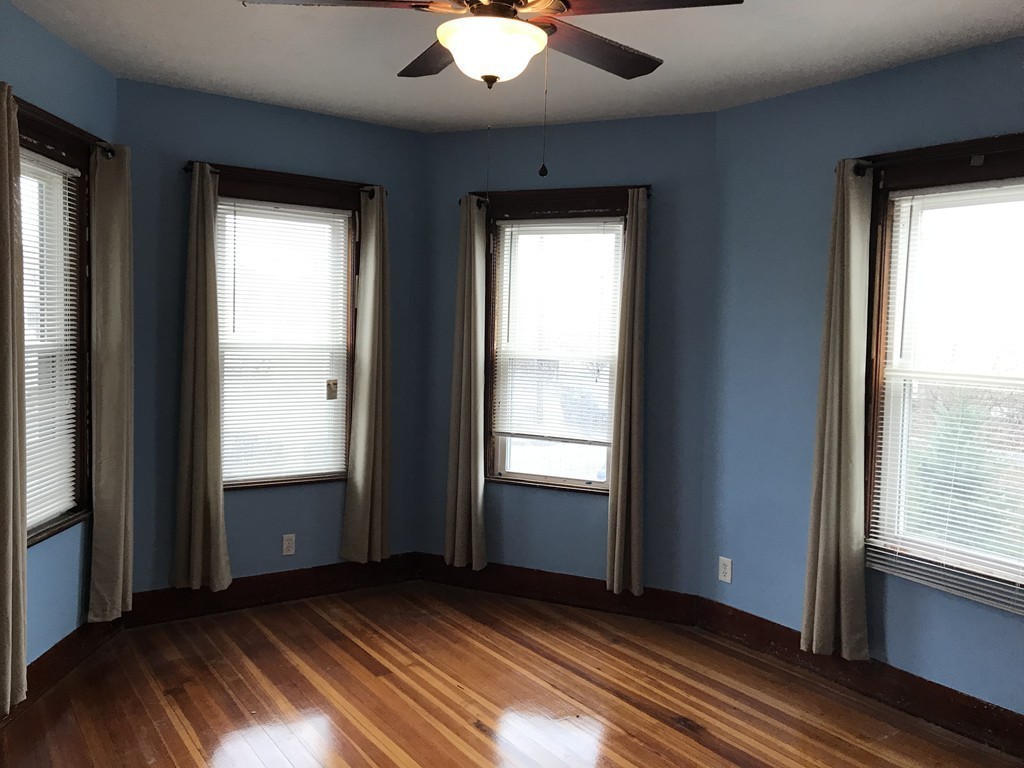 27 Floyd Street Revere, MA 02151 - Photo 11 of 21 a view of an empty room with wooden floor and a window