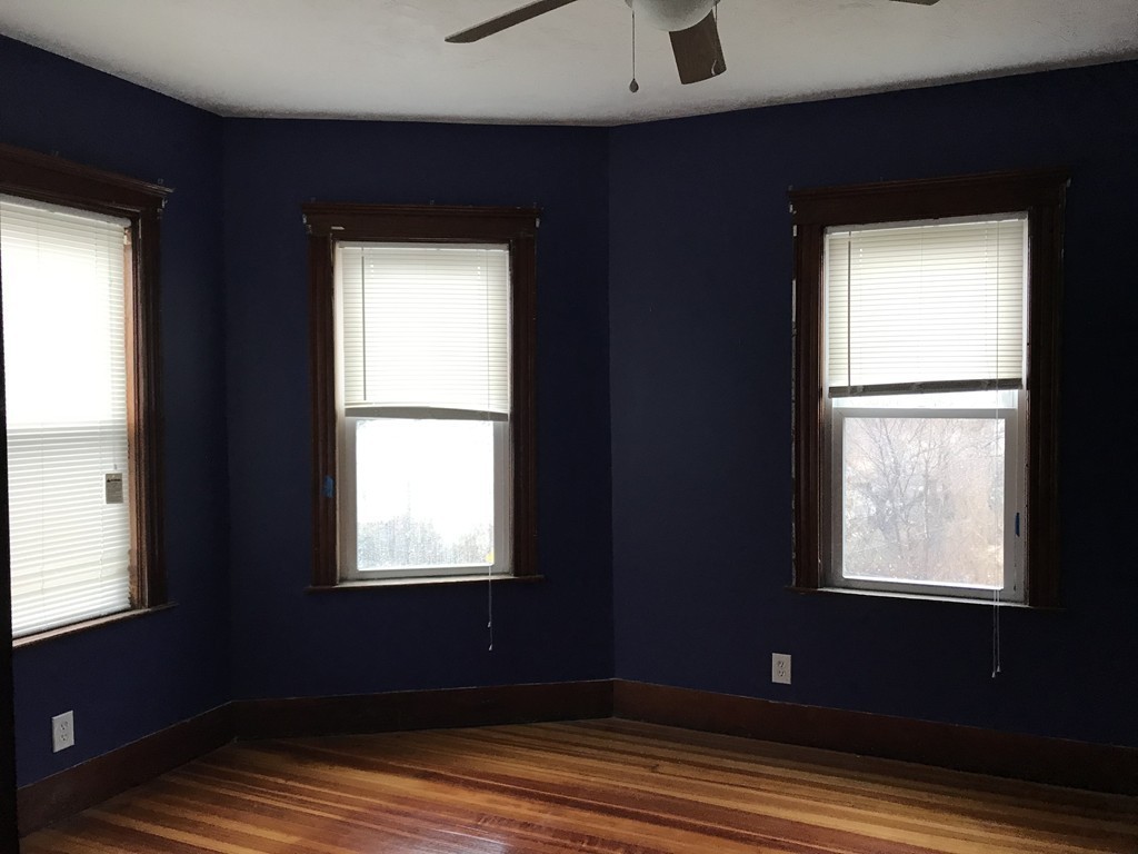 27 Floyd Street Revere, MA 02151 - Photo 14 of 21 a view of an empty room with wooden floor and a window