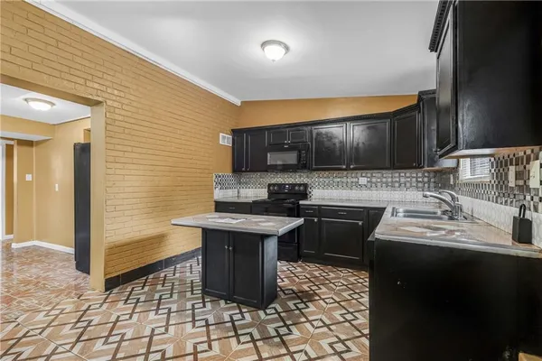 a kitchen with a sink stove and microwave