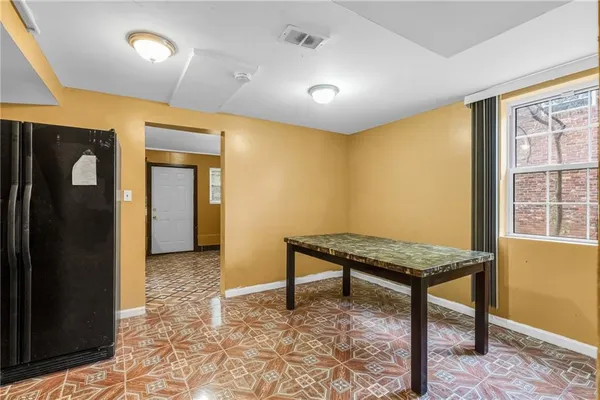 a living room with a table and chairs