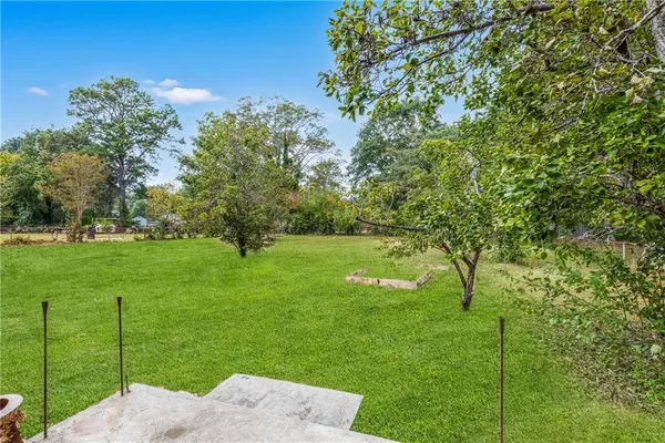 a view of a house with a backyard