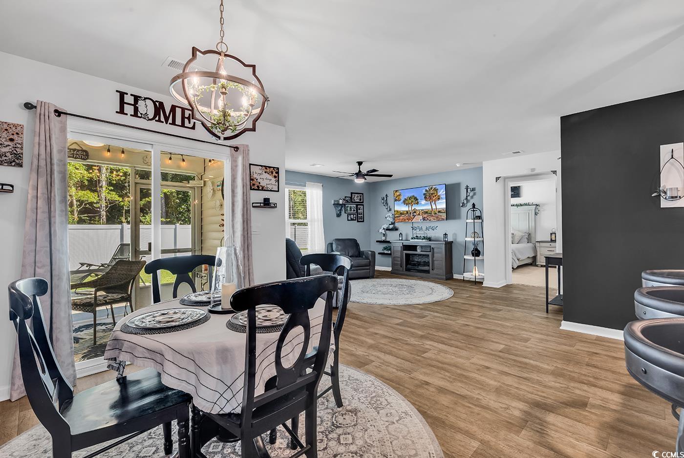 164 Seasons Trace Loop Longs, SC 29568 - Photo 13 of 40 Dining room featuring a ceiling fan, light wood-style flooring, and a chandelier